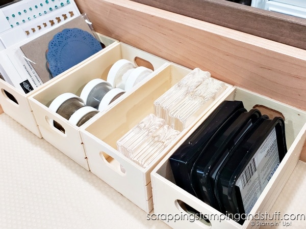 Click to see 12 ways to use a dollar tree crate for craft room organization! Organize your adhesives, embellishments, ink pads and more using a $1 wood crate!